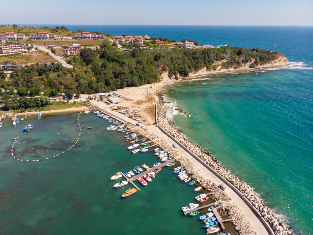 Aerial photo of the beautiful small town and seaside resort of Obzor in Bulgaria showing the fishing and marina side of the town showing fishing boats and the small sunny beach